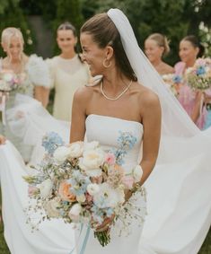 a bride and her bridal party walking down the aisle