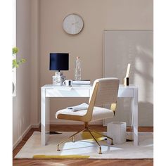 a white desk with a clock on the wall and a chair in front of it