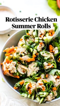 a bowl filled with cucumbers, carrots and other vegetables on top of a table