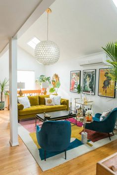 a living room filled with lots of furniture next to a wall mounted art piece on the wall