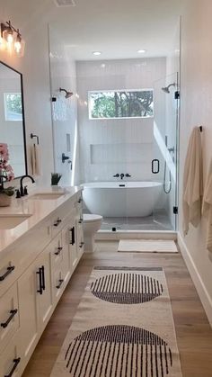 a bathroom with a bathtub, rug and sink