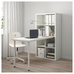 a white desk with a laptop on it and some drawers in front of the desk