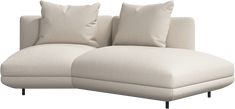 a white couch with two pillows on it's back and one arm facing the other