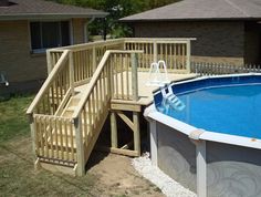 an above ground swimming pool with steps leading up to the deck and stairs on either side