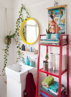 the bathroom is decorated in bright colors and has plants growing on the shelves above the sink