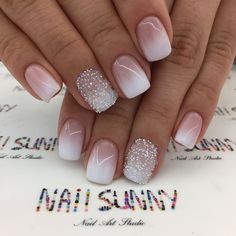 a woman's hands with french manies and glitters on their nails,