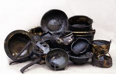 a pile of dirty pots and pans sitting on top of each other