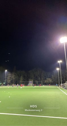 a soccer field is lit up at night