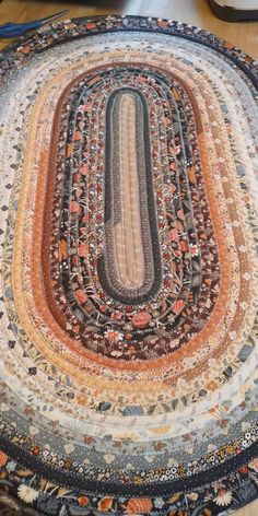 an oval rug on top of a wooden floor