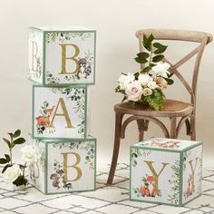 three wooden blocks with animals and flowers on them