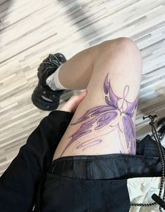 a woman's thigh with a flower tattoo on her lower half and the top part of her leg