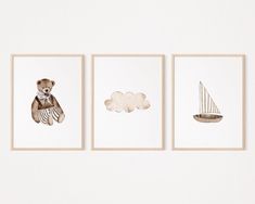 three framed pictures with animals on them hanging on the wall in front of a white wall