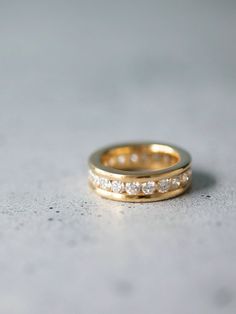 two gold wedding bands with diamonds on them