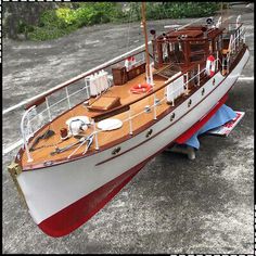 a model sailboat is sitting on the ground