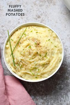 a white bowl filled with mashed potatoes on top of a table