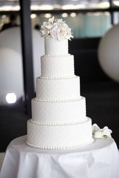 a white wedding cake sitting on top of a table