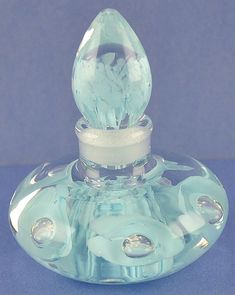 a clear glass bottle with a silver cap