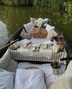 a boat filled with lots of pillows and plates on top of it's side