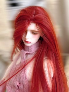 a red haired woman with long hair is posing for the camera