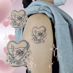 a woman with two heart tattoos on her arm