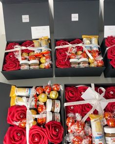 four boxes filled with different types of chocolates and candy wrapped in red ribbon bows