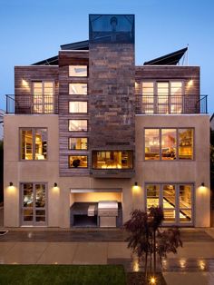 an apartment building with lots of windows and lights