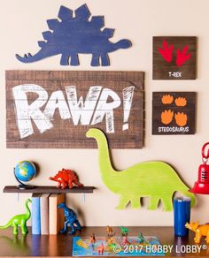 a wooden sign that says rawp with dinosaurs on it