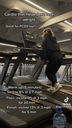 a woman is running on a treadmill