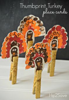 four turkey place cards on sticks with the words, thanksgiving turkey place cards written on them