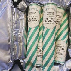 three green and white candy canes sitting on top of tinfoil wrapped in foil