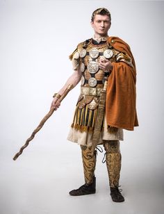 a man dressed in an ancient roman costume