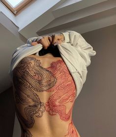 the back of a woman with tattoos on her body