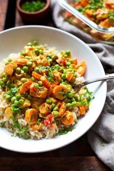 a white bowl filled with rice and vegetables next to a glass dish full of peas