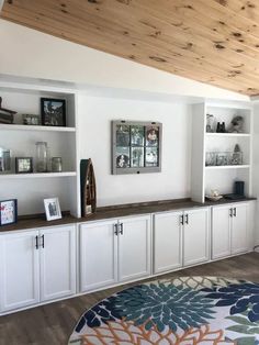 an image of a living room with white cabinets