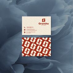 two business cards on top of each other with an image of flowers in the background