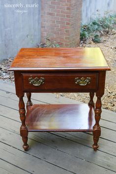 an old wooden table with two drawers on top and one drawer open to show the bottom