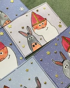 four cards with animals wearing hats and stars on them, all decorated in different colors