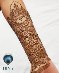 a woman's arm with henna tattoos on it