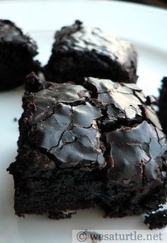 chocolate brownies on a plate with one cut in half