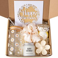 a birthday gift box filled with candles, cookies and other items for someone's special occasion