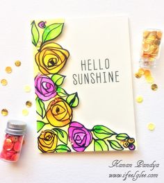 a hello sunshine card with flowers and confetti on the table next to it