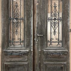 two wooden doors with wrought iron designs on the front and back sides, one is open