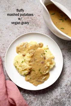 a plate with mashed potatoes and gravy on it next to a serving dish