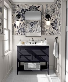 a bathroom with two sinks and a large mirror on the wall next to it is decorated in black and white flowers