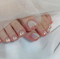 a woman's feet with french manies and a veil