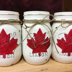 three mason jars painted with the canadian flag