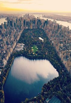 an aerial view of central park and the lake in new york city, ny at sunset