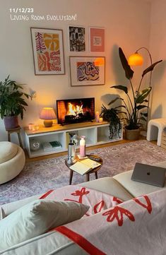 a living room filled with furniture and a fire place next to a tv mounted on the wall