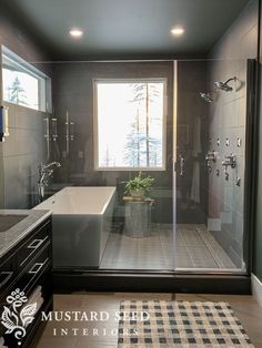 a bathroom with a tub, sink and shower in it's own area next to a window