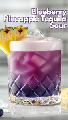 a blueberry pineapple tequila sour is garnished with a slice of fruit